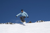 Snowboarder jumping in the mountains